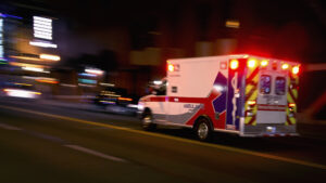 Personal Injury Lawyer Bloomington IL - An ambulance speeding through traffic at nighttime