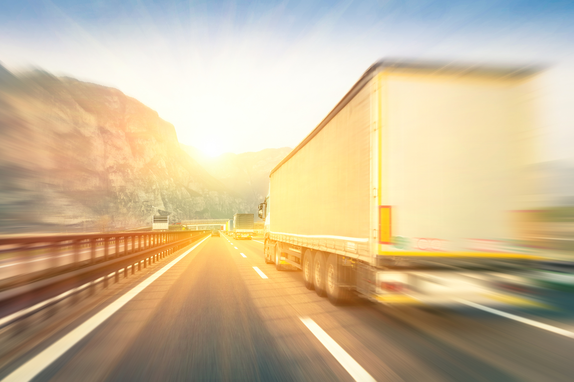 Deadly Jackknife Accidents - Generic semi trucks speeding on the highway at sunset - Transport